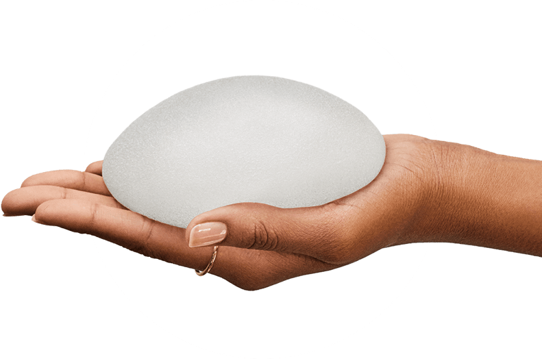 Hand Holding Breast Implant